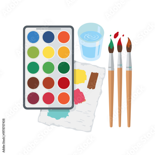 Artistic watercolor set with paint brushes, paper, and glass of water, creativity and artistic expression materials, school supplies for painting lessons and art classes concept.