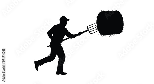 Man in silhouette running with a large hay bale on a pitchfork