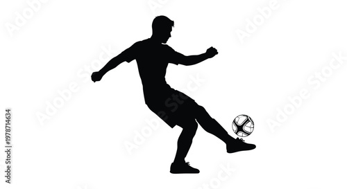 Silhouette of a man kicking a soccer ball