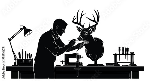 Silhouette of a man working on a deer taxidermy project in a workshop