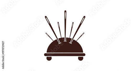 A dark brown pincushion is shown with several sewing needles stuck into its surface