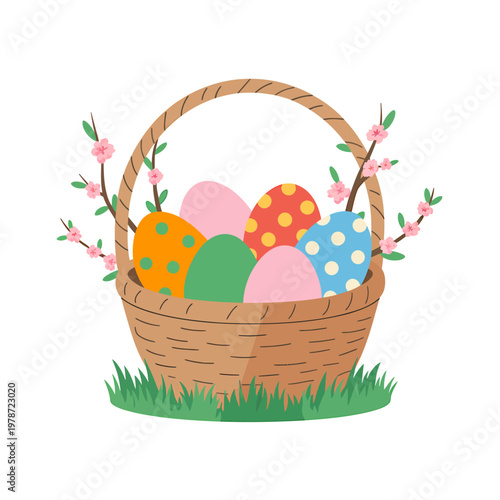 Easter eggs in a wicker basket with flowers on grass