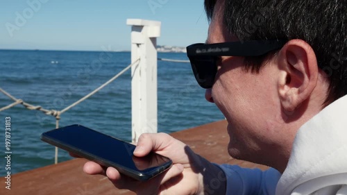 Man talking on smartphone with voice call, mobile communication technology.