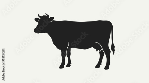 Black silhouette of a cow standing.