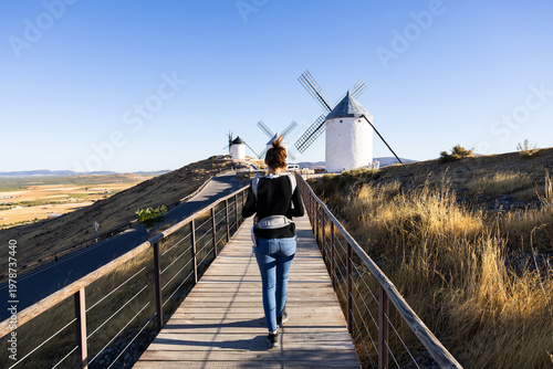 Woman with baby carrier walking to Consuegra windmills