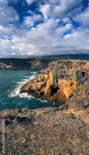 Colorful volcanic cliffs and turquoise ocean in La Caleta Tenerife Canary Islands
