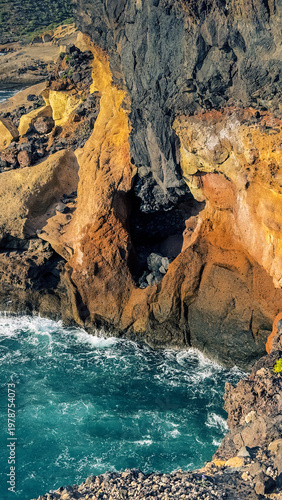 Colorful volcanic cliffs and turquoise ocean in La Caleta Tenerife Canary Islands
