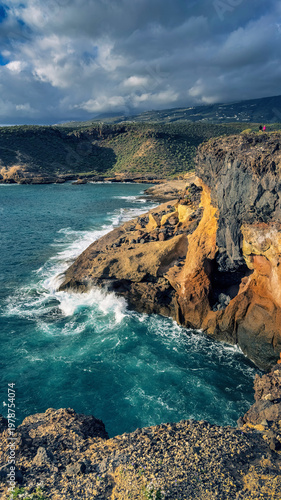 Colorful volcanic cliffs and turquoise ocean in La Caleta Tenerife Canary Islands