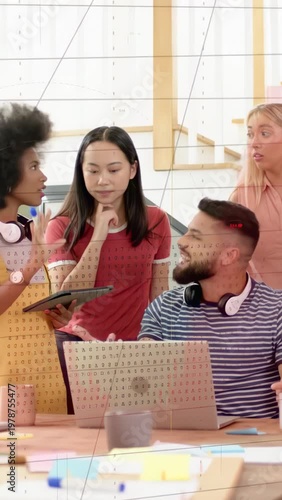 Vertical video: Tech team tapping tablet laptop lead reviewing data while chart overlay animating