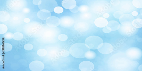 Blue bokeh abstract winter background with glowing blurred lights and soft festive sparkle design