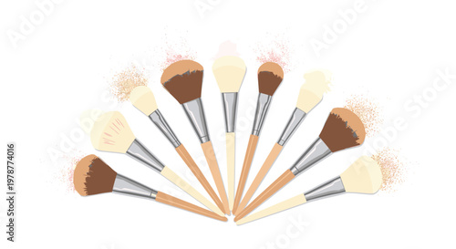 Nine professional makeup brushes with natural wooden handles are arranged in a wide fan shape beneath clouds of shimmering cosmetic powder on white.