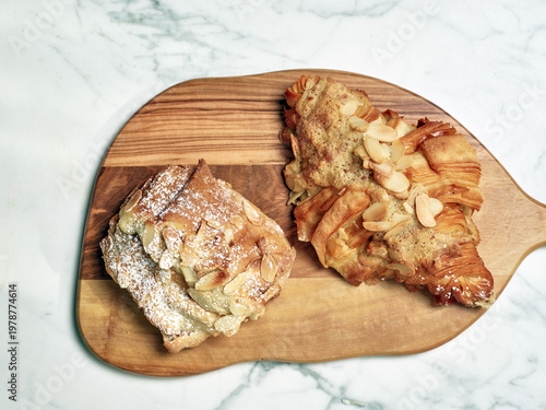 Baked goods dessert almond pastries on wooden plate