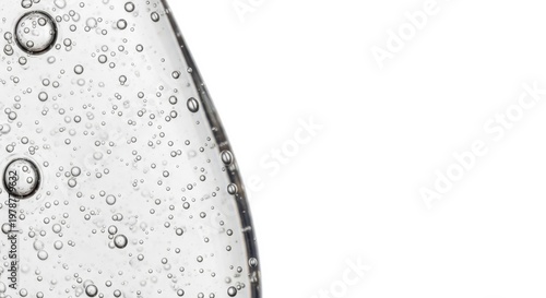 Close-up of clear liquid with numerous small bubbles and copy space.