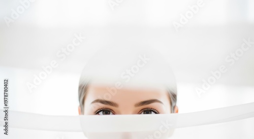 Womans Eyes Peeking Through White Fabric with Minimalist Aesthetic.