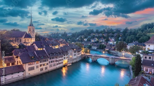 Bern, Switzerland. Cityscape with Untertorbrucke (Lower Gate Bridge) and Aare river at dusk (static image with animated sky)