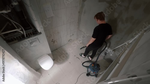 Man cleaning bathroom during renovation