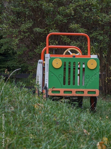 Colorful green and orange wooden toy car designed for children to play in the park