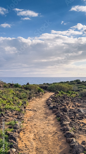 Coastal path with hikers and ocean view in La Caleta Tenerife Canary Islands
