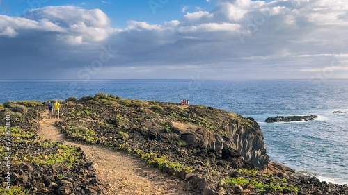 Coastal path with hikers and ocean view in La Caleta Tenerife Canary Islands