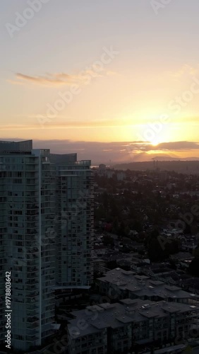 Breathtaking Sunset Over New Westminster, British Columbia: Aerial View of a Modern Cityscape with Residential Buildings