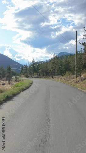 Winding Road Through Majestic Forests And Mountains In British Columbia, Canada On A Bright Sunny Day
