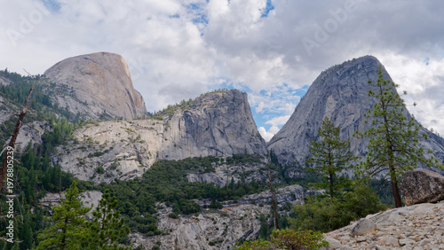 Scenic vista of Liberty Cap and Half Dome peaks above the forest, Yosemite National Park, California, USA