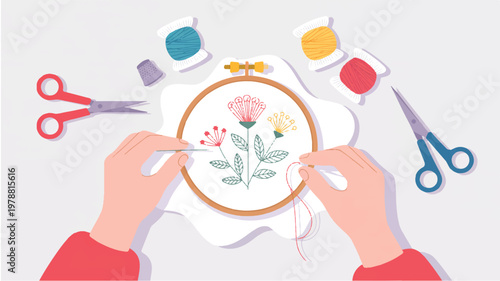 person embroidering flowers with thread and needle on fabric in hoop