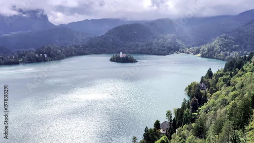 lake bled island church reflection with castle on mountain cliff background (famous european travel tourism destination in julian alps) slovenia europe scenic landscape sunset glow boat rowing nature