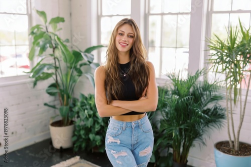 Model Poses in a Sunny Indoor Garden With Green Plants and Bright Windows