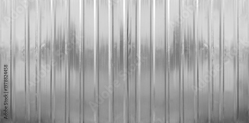 Silver tin iron corrugated wall with horizontal stripes from a metal profile of a metal sheet. Texture, background. grey wall fence texture for backdrop galvanized gray facade.