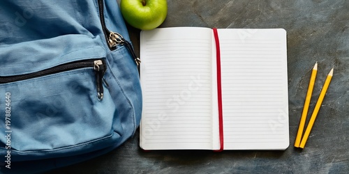 Backpack With Green Apple and Open Notebook on a Table Ready for Study at School