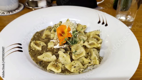 european buckwheat dumplings seved in restaurant in slovenia with beautiful flower decor healthy organic local produce eastern europe culinary tradition