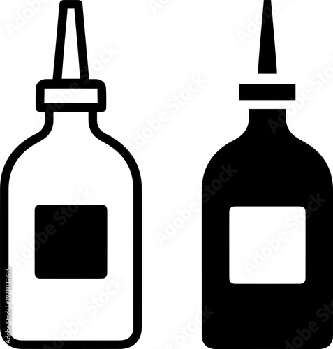 Two black and white glue bottles with labels on a plain background