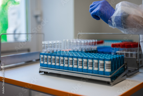 Foto Sample Rack Filled With Labeled Vials On Bench, Orderly Rows Of Tubes In Blue Ho