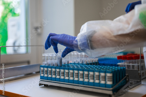 Photos Sample Rack Filled With Labeled Vials On Bench, Orderly Rows Of Tubes In Blue Ho