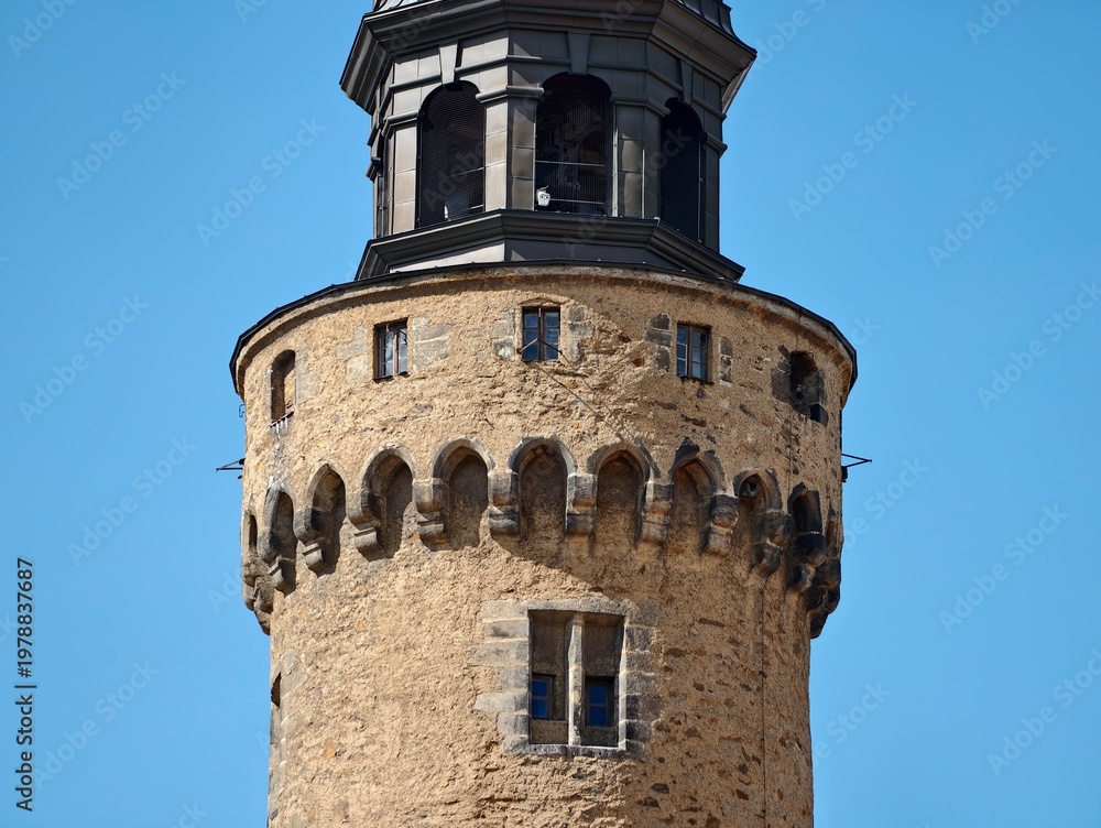 Obraz premium Stone fortress under bright day. Photograph capturing weathered tower with detailed architecture