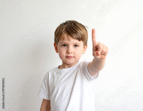 Young boy pointing up with his finger, showing number one.
