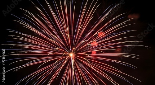 Red and white fireworks exploding against dark background