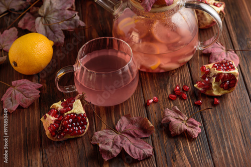 Autumn Pomegranate Tea with Lemon and Ginger on Rustic Table