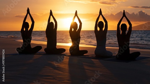 Yoga Practice on the Beach During Sunset With Group of People Stretching Toge...