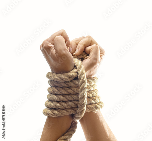 Tied female hands trying to break rope. Freedom, escape, resistance and overcoming limitations.