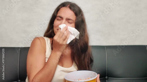 Crying emotional young woman watching sad movie