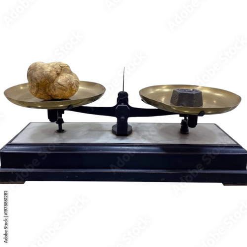 White truffle balancing on vintage scale with measuring weight