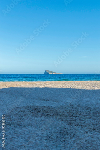 Deserted Poniente Beach with Benidorm Island.