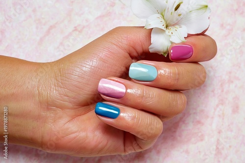Colorful Nails With Flowers on Hand During a Nail Art Session Indoors