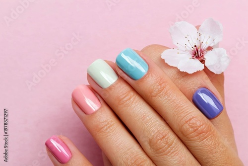 Colorful Nails With Flowers on a Pink Background During Spring Season
