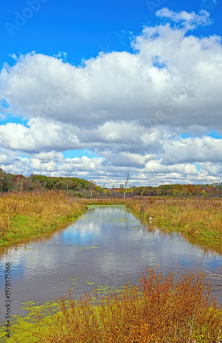 Puffy Clouds Over a River Channel on a Fall Day