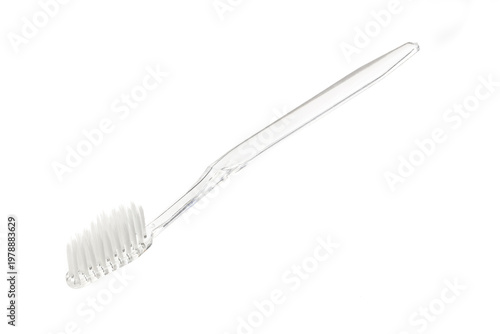 Transparent plastic toothbrush isolated on white background. Close-up