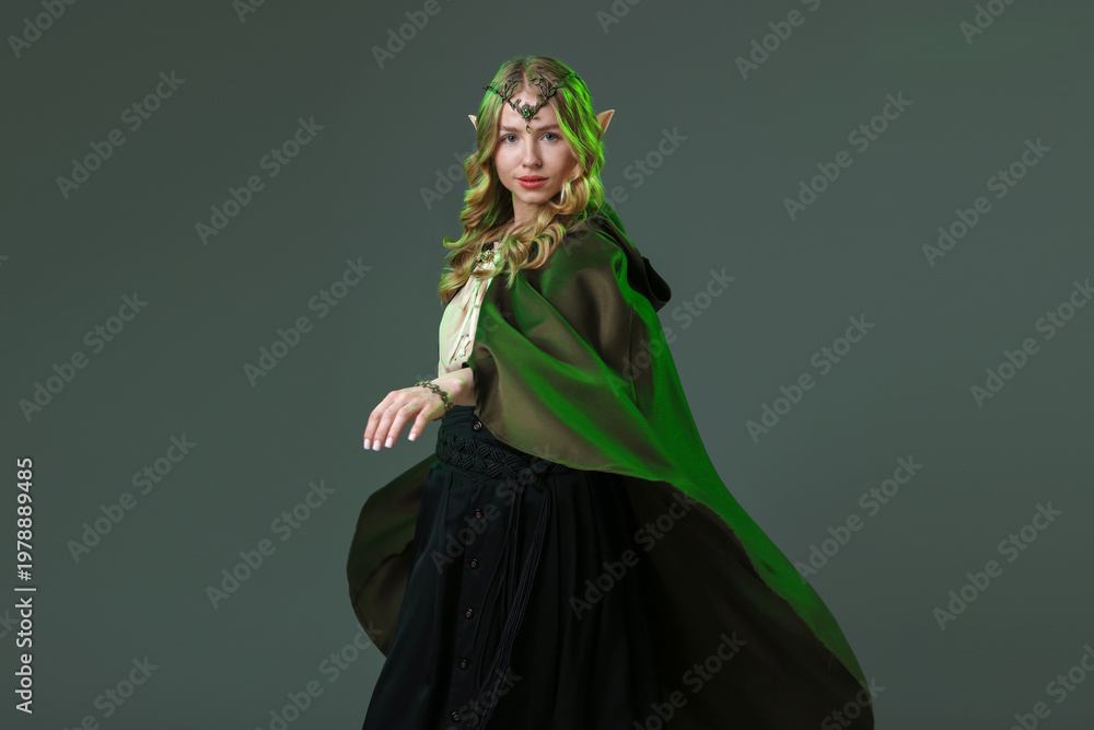 Naklejka premium Beautiful girl dressed as elf on grey background