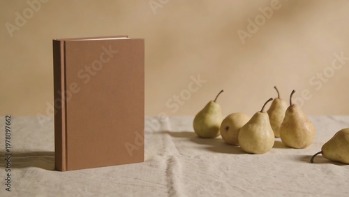 Stylish brown book with ripe pears on a textured table setting for National Book Day